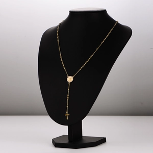 Elegant gold cross pendant necklace on 3mm bead chain displayed on black mannequin torso
