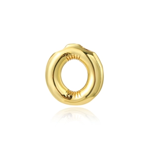 Close-up of golden round earring with irregular inner texture and 18K gold plated finish