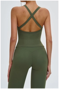 Detail view of the back criss-cross straps and ribbed texture on the dark green yoga top