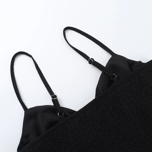 Detail of black camisole showing elastic smocked fabric and adjustable thin straps