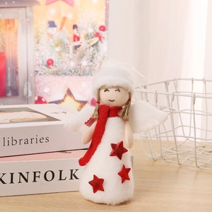 Detail of Christmas angel doll with red knit scarf and glitter star on wooden desk