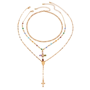Gold-tone multilayer Y-necklace with colorful beads and cross pendants on white backdrop