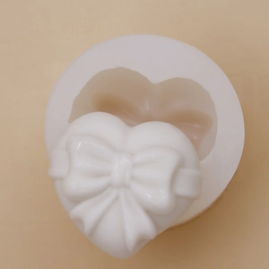 Macro detail of heart-shaped silicone mold with 3D bow ribbon texture for baking
