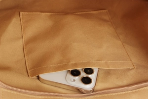 Close-up of the internal open pocket of a woven bag showing its durable canvas lining