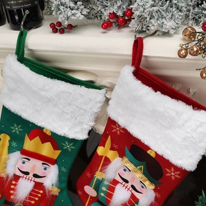 Red and green Christmas stockings with nutcracker soldier patterns and plush white trim