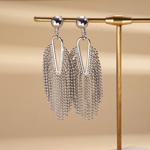 Detailed view of silver-tone tassel earrings featuring hollow geometric shapes and beaded chains