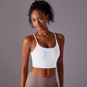 Close-up of white yoga tank top featuring slim straps and a minimalist U-neck design