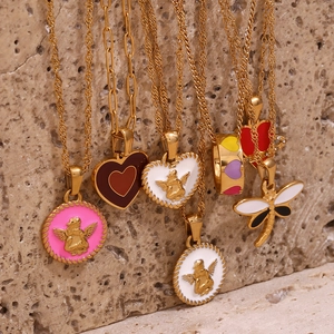Detail of 18K gold plated necklaces with colorful enamel heart and angel pendants