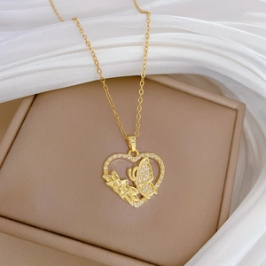 Golden heart and butterfly necklace with clear zircons on beige leather jewelry box