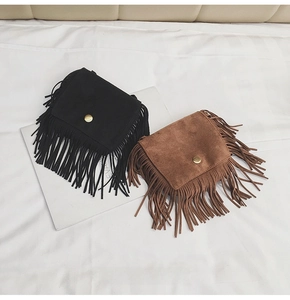 Detail of leopard print suede tassel crossbody bags for girls in black and brown colors