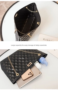 Detail of the black quilted chain bag showing its large interior capacity for essentials