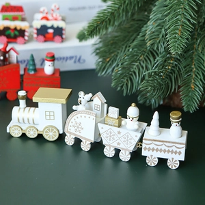 White and gold wooden Christmas train set with snowmen and gift boxes on dark background