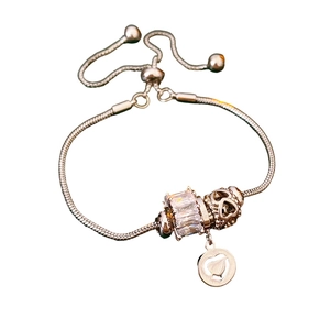 Silver snake chain bracelet with large rectangular zircon and heart-shaped charms on white