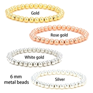 Stack of 6mm polished metal bead elastic bracelets in gold, rose gold, and silver finishes