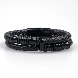 Detailed view of the black braided leather layers and polished magnetic metal clasp