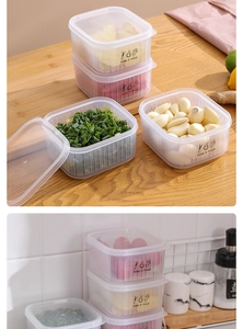 Detail of transparent food storage containers for ginger and garlic with leak-proof lids