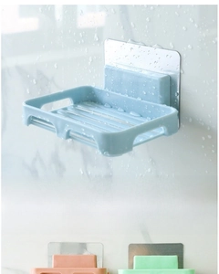 Detail of wall-mounted soap dish with drainage slots and adhesive back in various colors