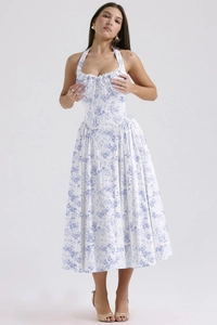 Detailed close-up of blue floral print with delicate white lace trim on a halter dress