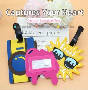 Detail of colorful PVC luggage tags featuring sun, camera, and rabbit shapes