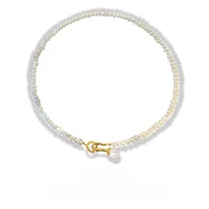 Detailed macro view of S925 silver clasp and drop pearl pendant on a fashion necklace