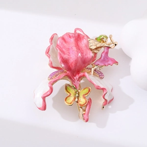 Detailed macro shot of vintage enamel flower brooch with fairy and butterfly design