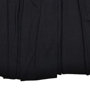 Detail shot of black synthetic fabric showing elegant vertical pleats and material texture