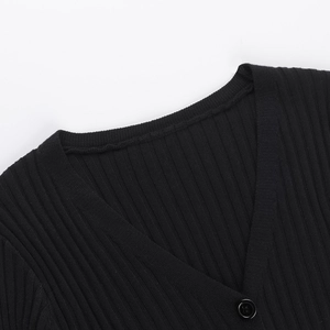 Close-up of black ribbed knit cardigan featuring a deep V-neck and button details