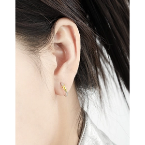 Minimalist S925 sterling silver geometric hoop earrings with gold star accents on model