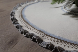 Detail of knitted Christmas tree skirt with Fair Isle patterns and soft fringe tassels