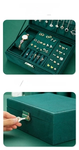 Macro view of velvet jewelry box with specialized compartments for rings and watches