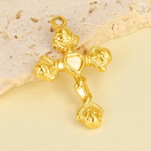 Macro shot of 304 stainless steel gold cross pendant with embossed heart detail