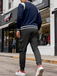 Detailed view of dark grey cargo joggers with side pockets and elastic cuffed hems
