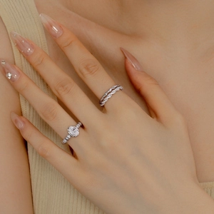 Close-up of S925 sterling silver stacked rings with oval zircon and pavé diamonds