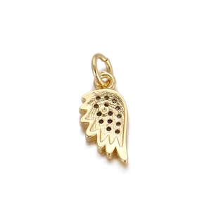 Macro shot of gold-plated copper wing pendant showing detailed texture and jewelry DIY loop