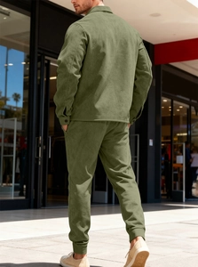 Rear view of olive green men's heavy suede jacket and pants set in urban street setting