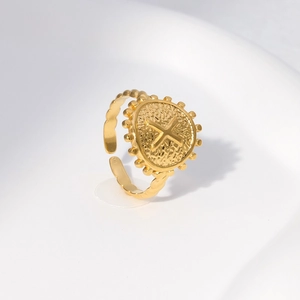 Macro detail of gold vintage signet ring with embossed X motif and hammered texture