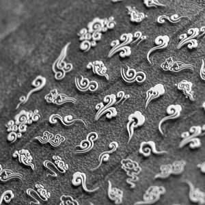 Detailed macro view of 5D silver metallic lucky cloud nail stickers with embossed texture