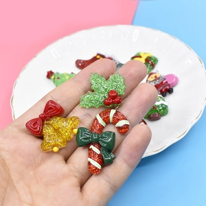 Glittery Christmas resin charms featuring golden bells, candy canes and holly leaves