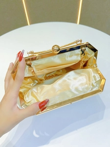 Elegant gold evening clutch bag with metal frame, satin lining, and detachable chain strap