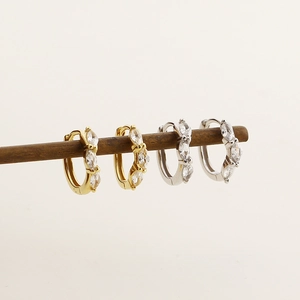Macro shot of gold and silver S925 sterling silver marquise zircon hoop earrings
