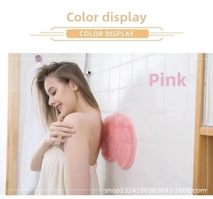 Pink silicone back scrubber and foot massage mat with suction cups on bathroom wall