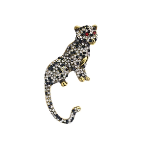 Vintage leopard brooch in gold-tone alloy with sparkling black and white rhinestones