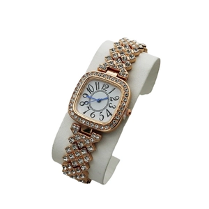 Elegant gold square watch for women with rhinestone inlay and blue hands on white pillow