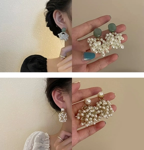 Detail of flower earrings with white pearl tassels and green geometric studs on model
