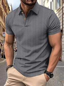 Detail of dark gray men's knit polo shirt featuring a premium textured chevron fabric
