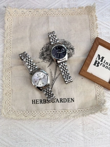 Macro shot of stylish steel ladies watch with calendar window on a linen background
