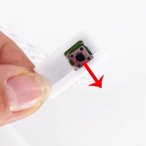 Close-up of three-level white button switch module with internal green circuit board
