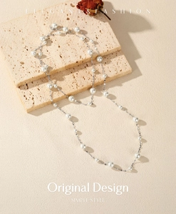 Elegant S925 silver necklace featuring multiple white pearls on a textured travertine stone