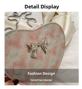 Detail of heart-shaped PU bag featuring pastel marble texture and silver metal bow