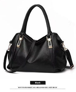 Detailed view of large black pebbled leather handbag featuring elegant gold hardware.